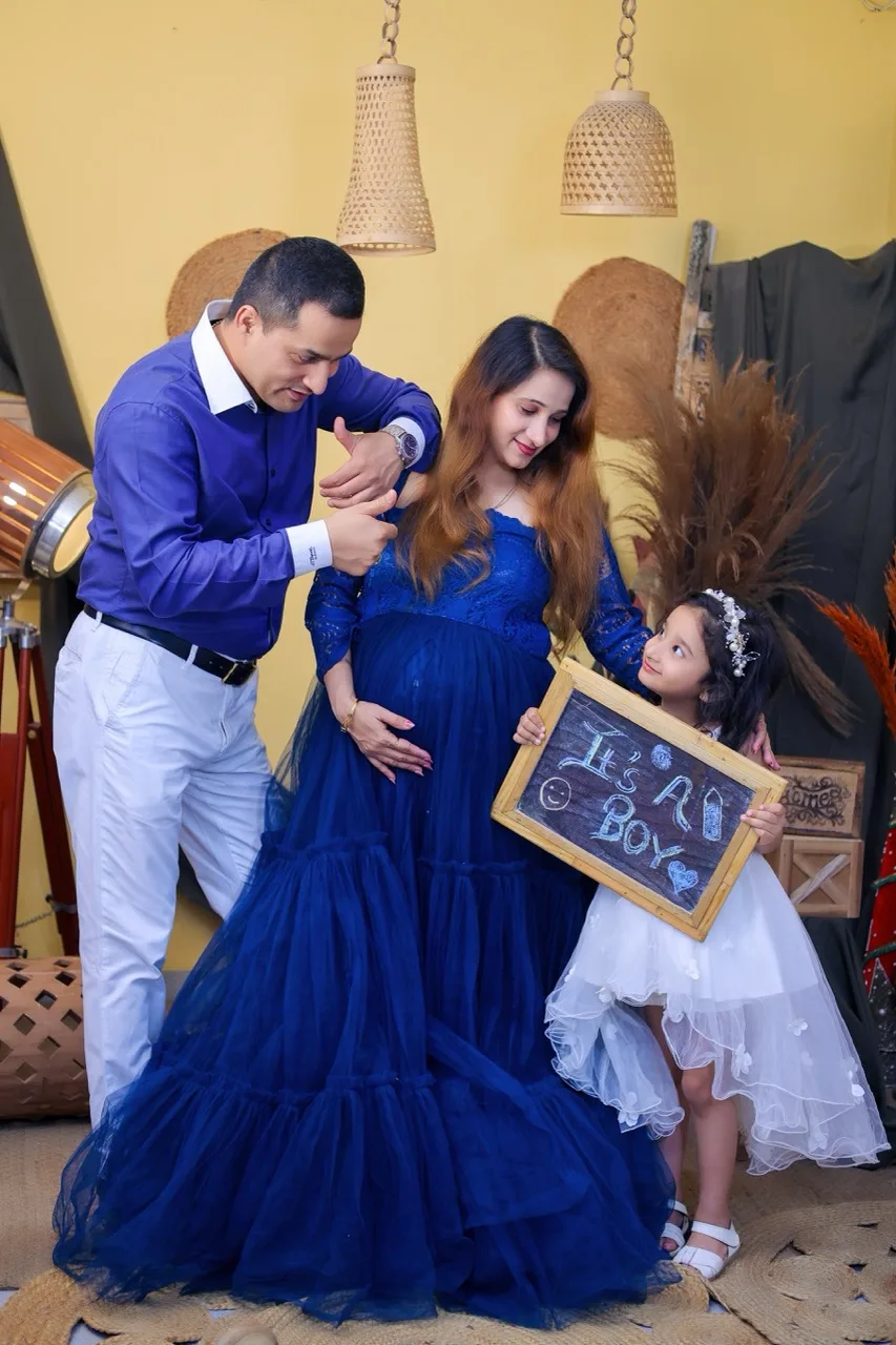 Family portrait with expecting mother, husband, and their second child during a baby bump session