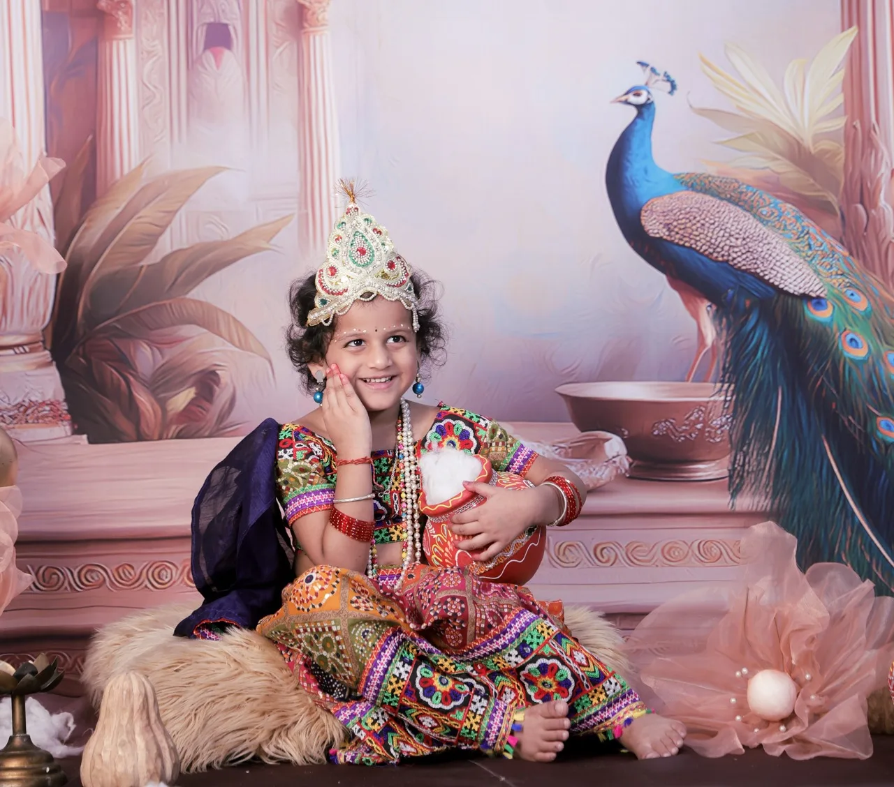 Smiling baby girl dressed as Radha for Janmashtami Aangan theme photoshoot, Janmashtami Krishna theme baby photoshoot in Delhi NCR.