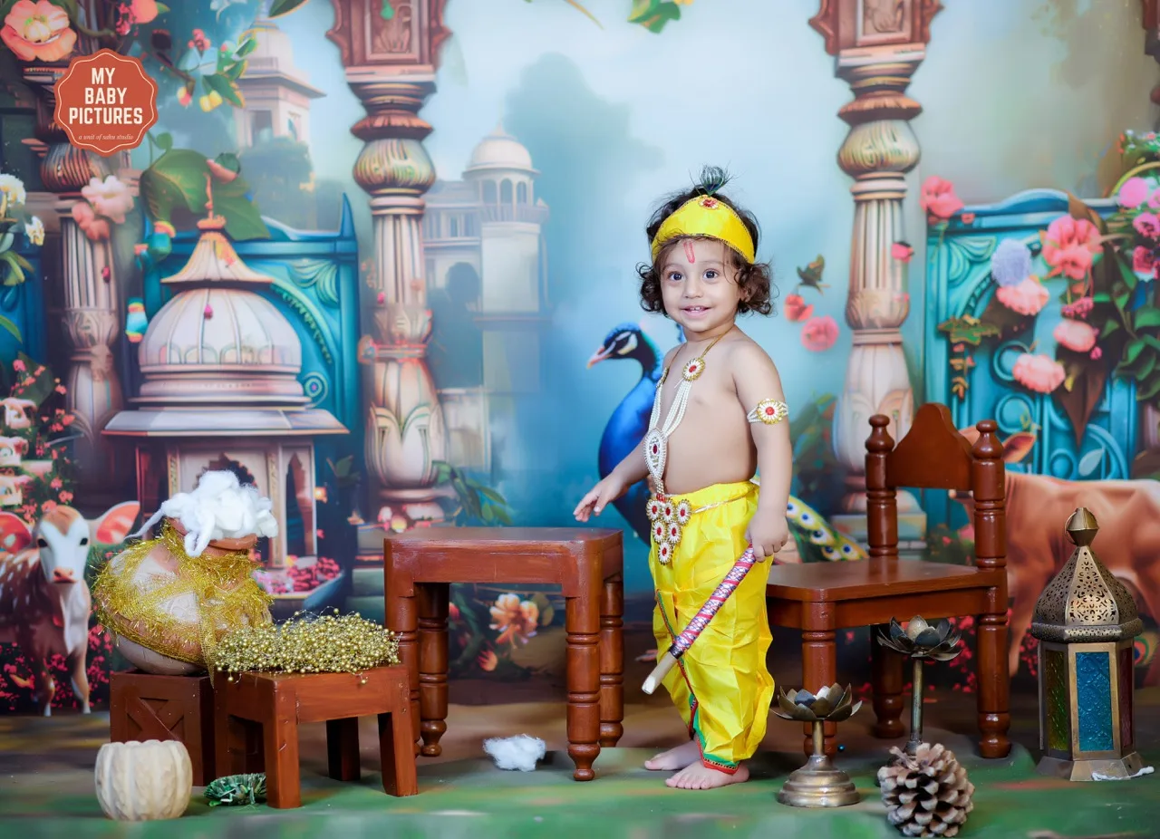 Toddler Krishna with a mischievous smile in a vibrant Gokul setting, Janmashtami Krishna theme baby photoshoot in Delhi NCR.
