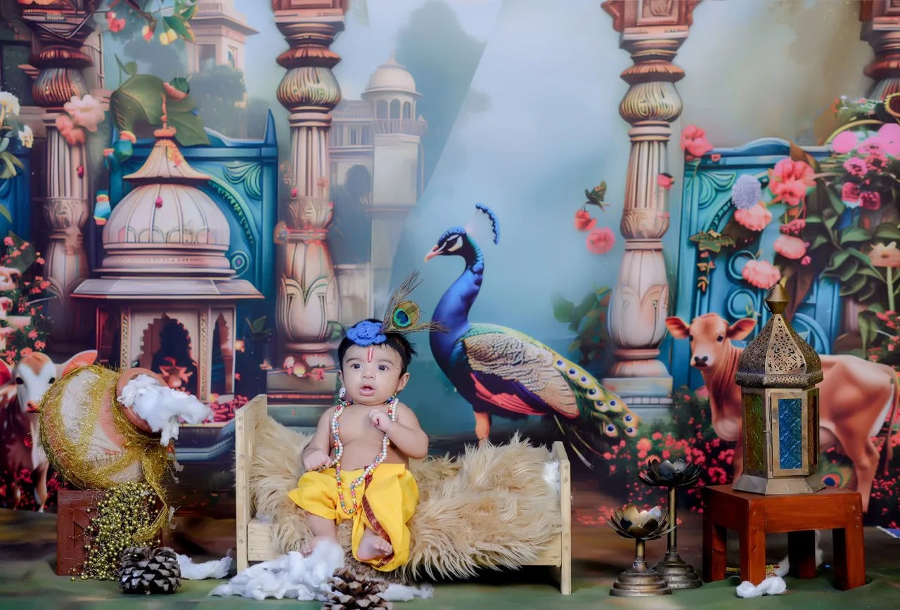 A cute baby boy as Krishna with a peacock feather on his head in a Gokul theme, Janmashtami Krishna theme baby photoshoot in Delhi NCR.