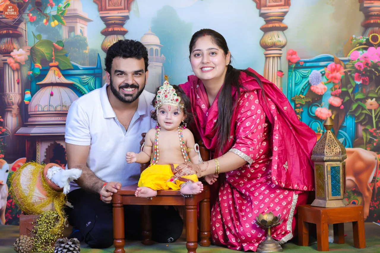 Family photoshoot with baby Krishna and his parents in a Gokul theme, Janmashtami Krishna theme baby photoshoot in Delhi NCR.