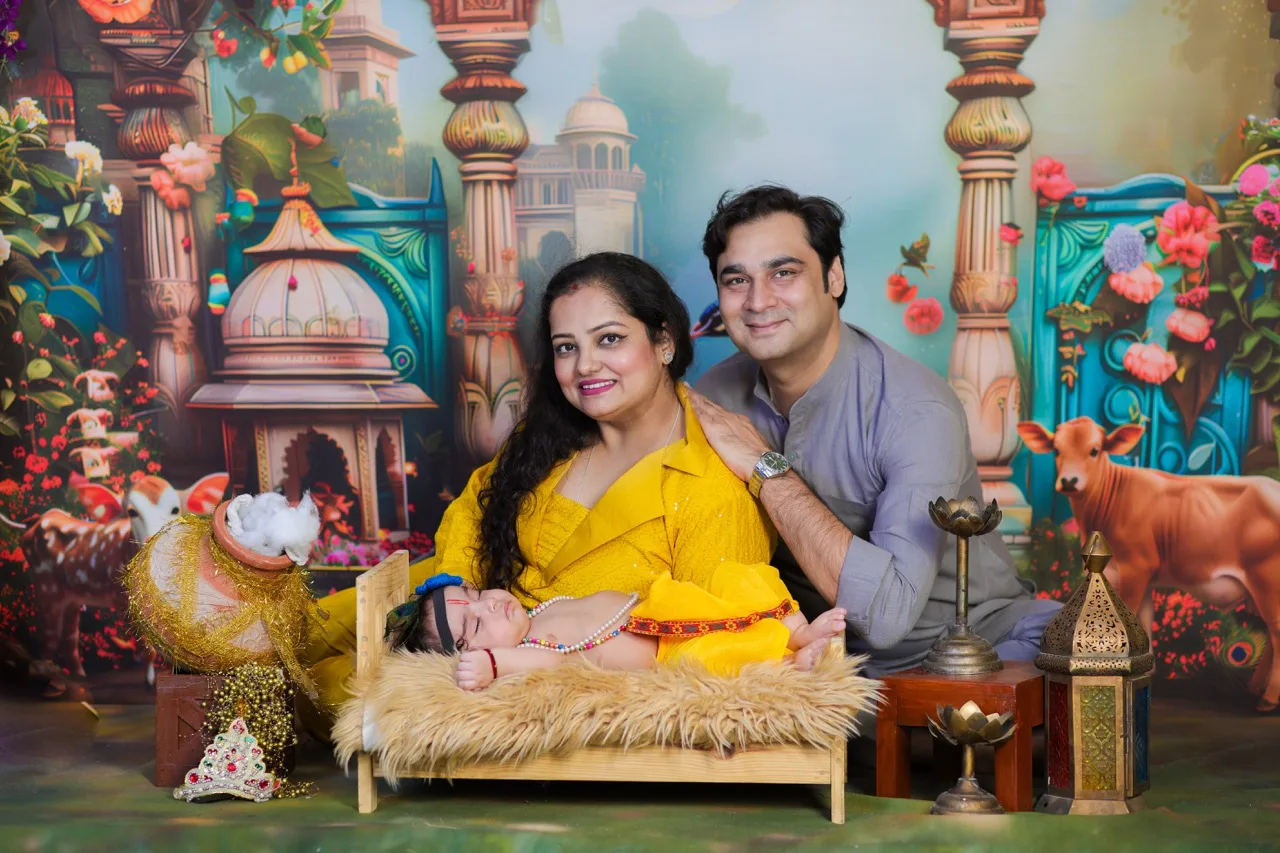 A beautiful family portrait with baby Krishna sleeping peacefully, Janmashtami Krishna theme baby photoshoot in Delhi NCR.
