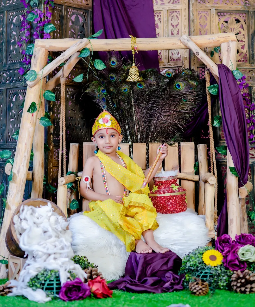 Toddler boy photoshoot in Delhi as Krishna on a beautiful swing, Janmashtami Krishna theme baby photoshoot in Delhi NCR.