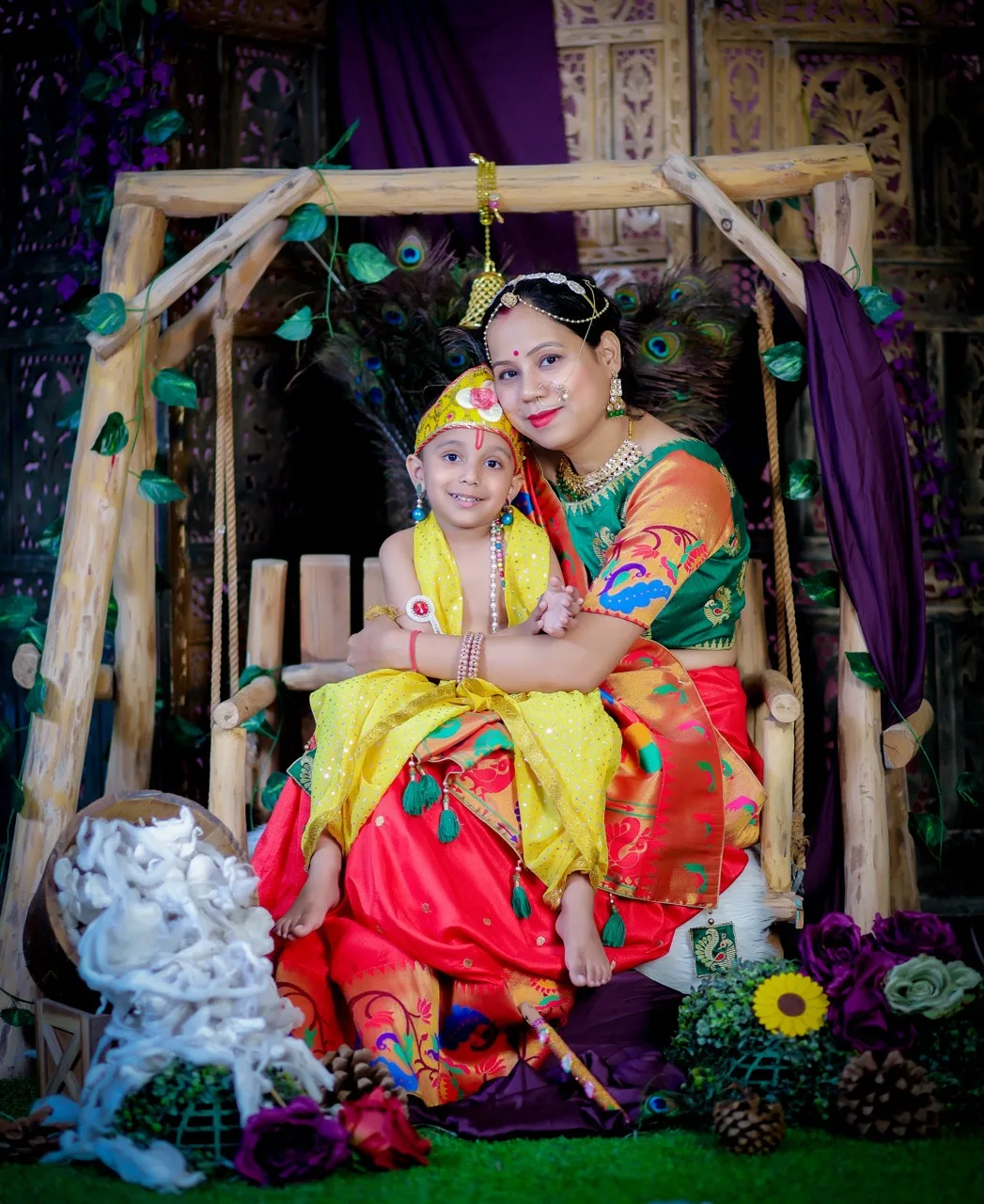 A mother and son portrait with the child as Krishna on a jhula, Janmashtami Krishna theme baby photoshoot in Delhi NCR.