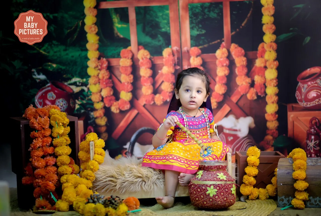 Baby girl in Radha dress for a colorful Vrindavan theme photoshoot, Janmashtami Krishna theme baby photoshoot in Delhi NCR.