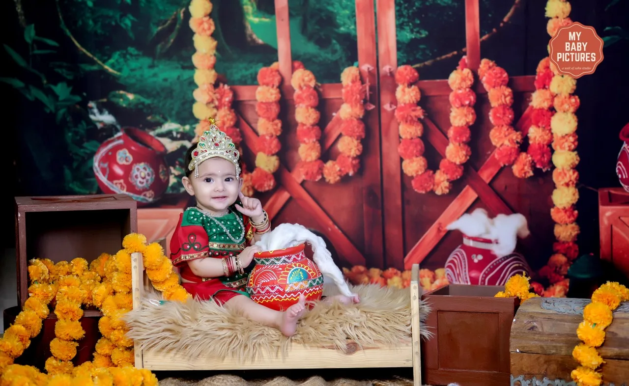 A happy baby girl as Radha with a butter pot in a Vrindavan setting, Janmashtami Krishna theme baby photoshoot in Delhi NCR.