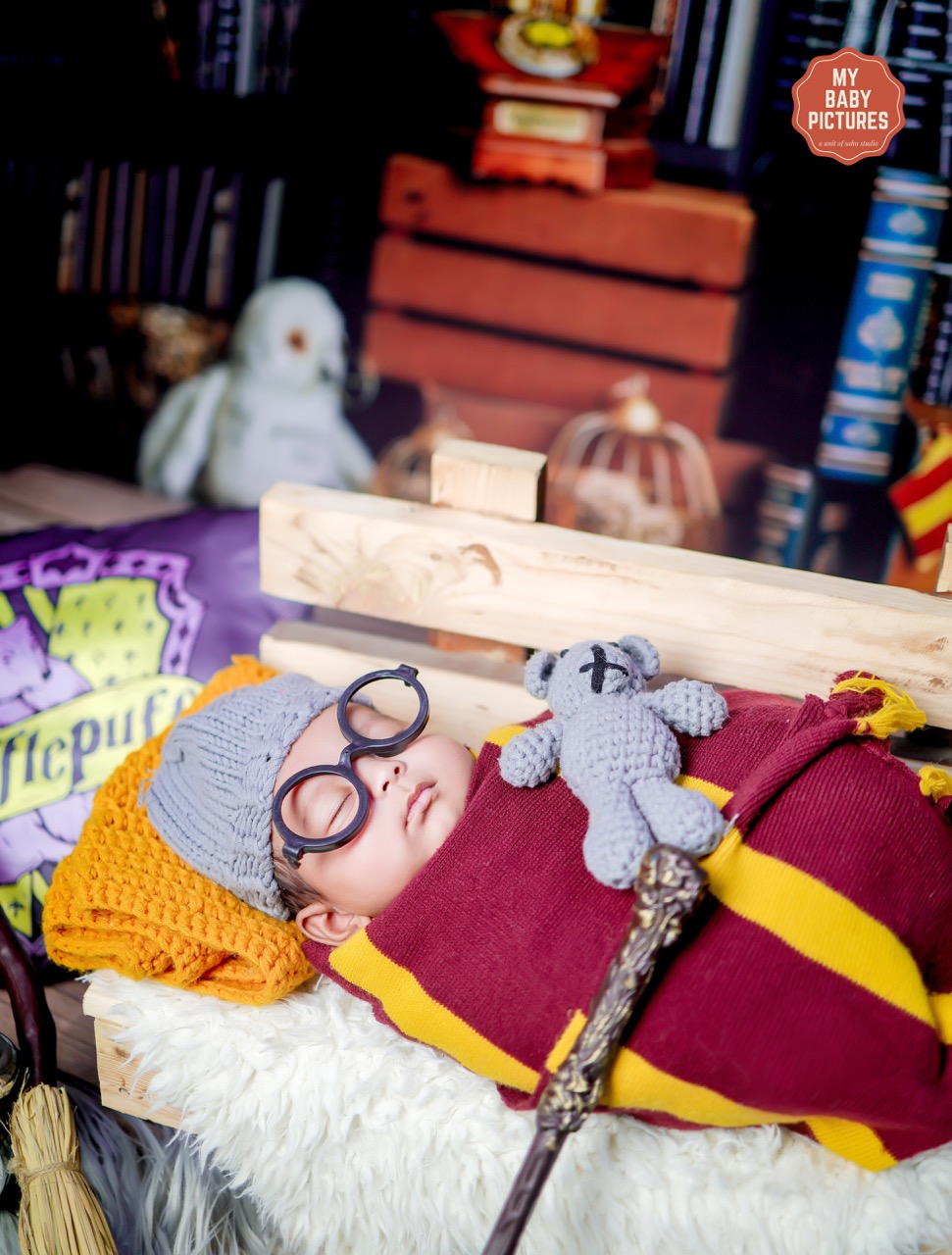Newborn in a wizard costume theme