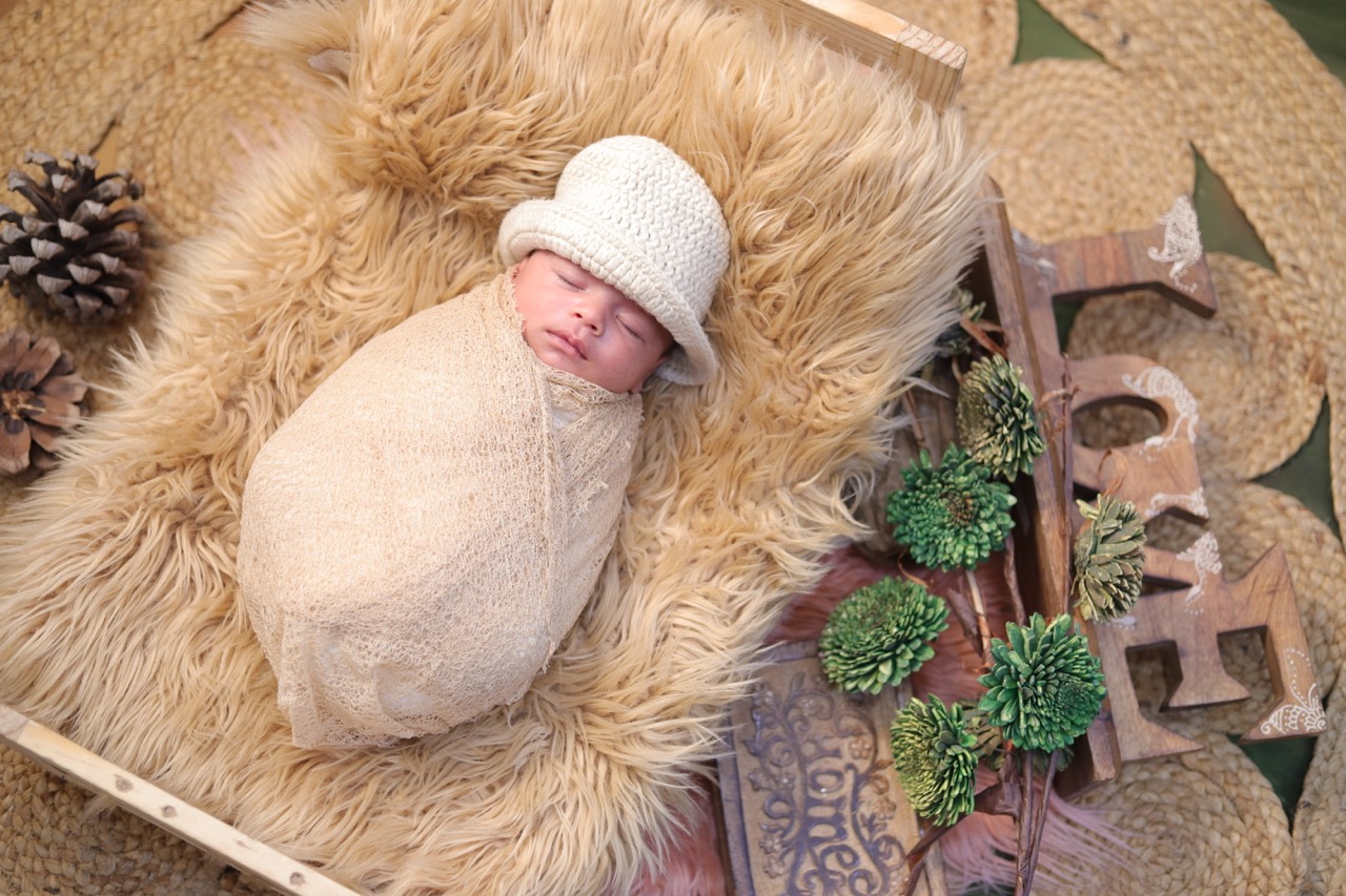 Newborn wrapped with LOVE prop